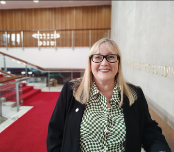 Councillor Karen Kilgour Leader of Newcastle City Council standing on red staircase in Newcastle civic centre