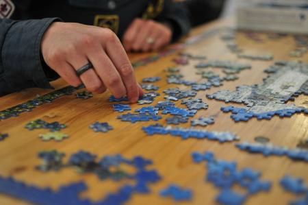 Person completing a jigsaw