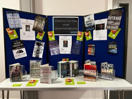 Blue display board showing book recommendations