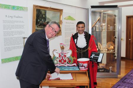 Peter Lassey, Chair of White Ribbon UK, signs the Lord Mayor's visitors book