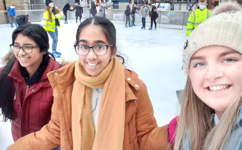 Three girls ice skating