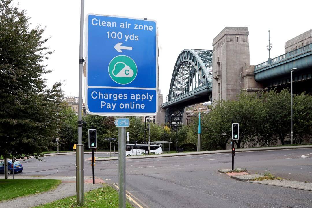 Photo shows Clean Air Zone road signage with the Tyne Bridge in the background..