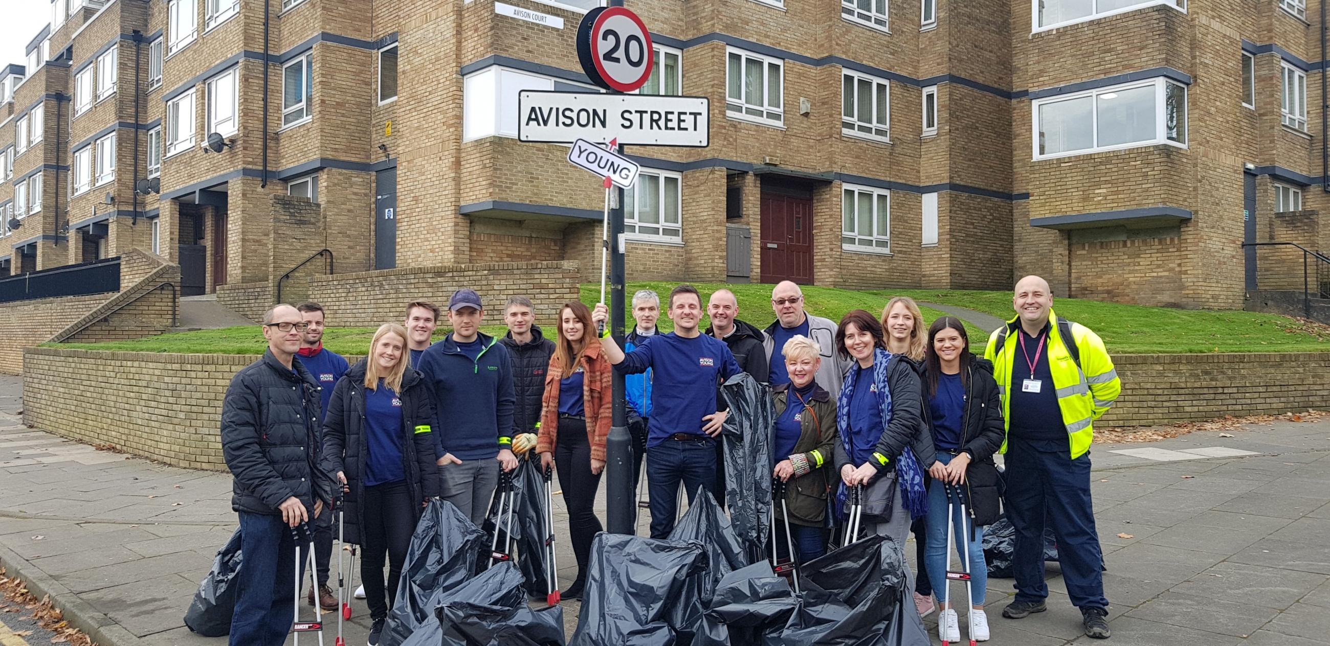 Volunteers from Avison Young clean Avison Street. 