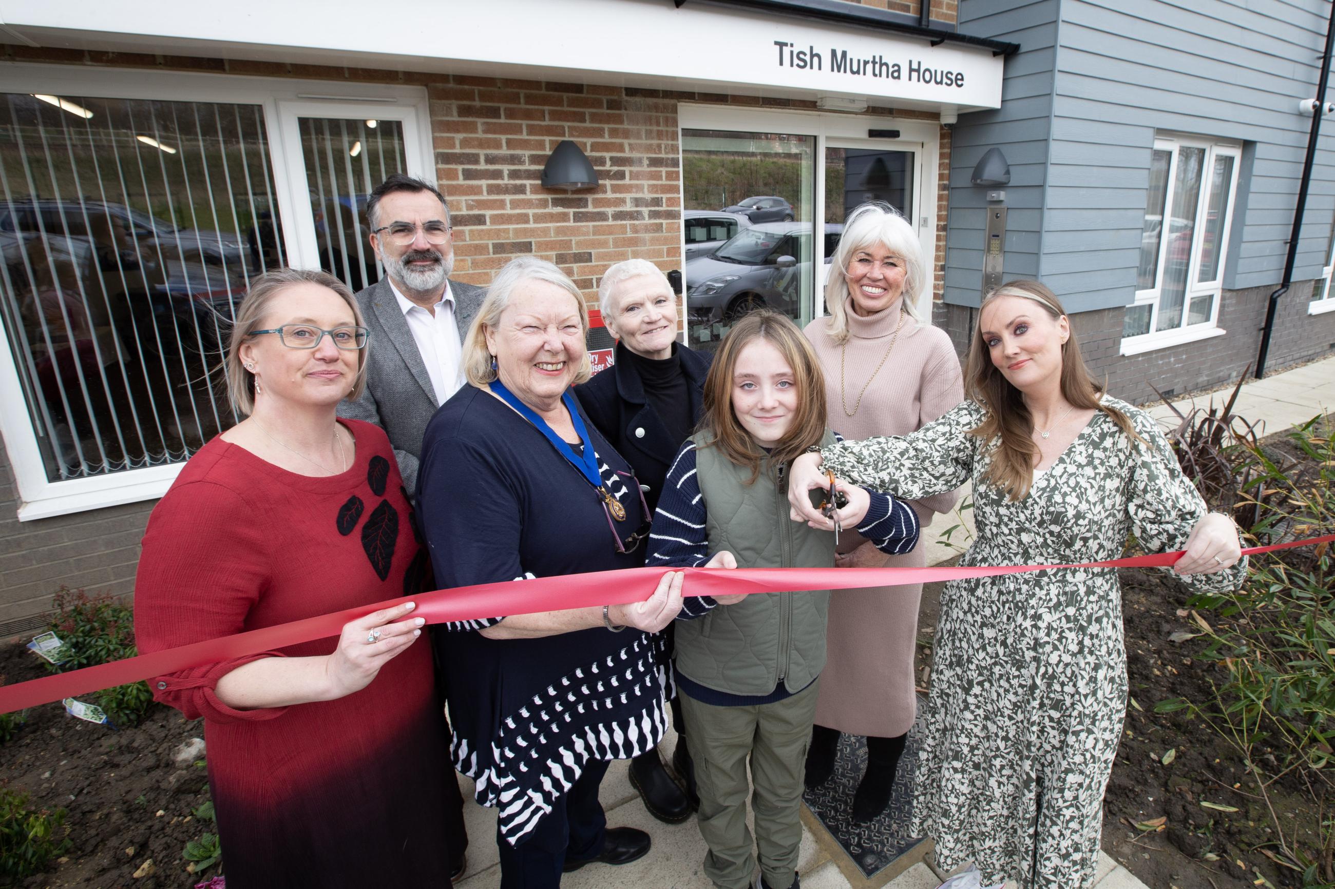 Ribbon cutting at the opening of Tish Murtha House