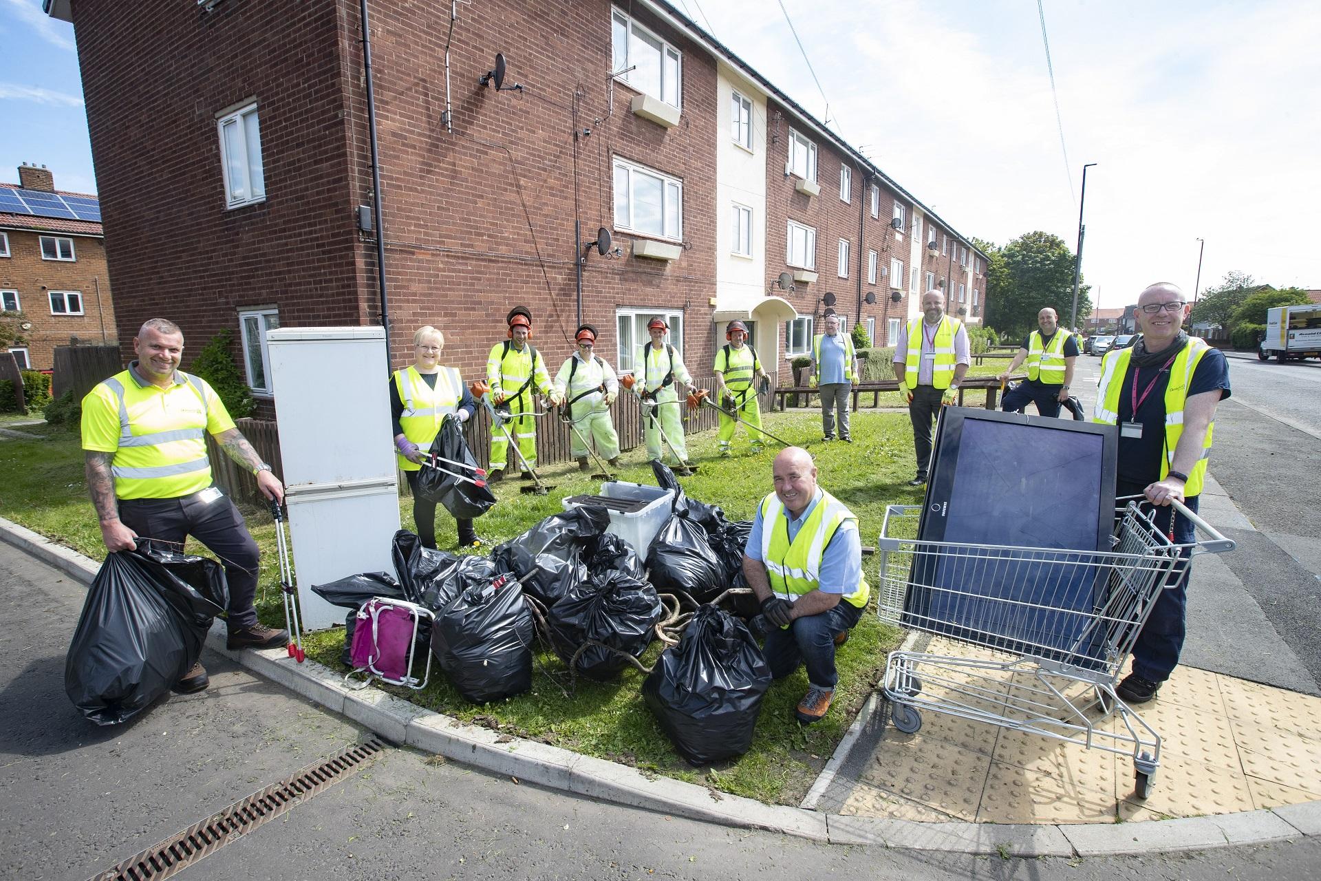 Cllr Ged Bell with staff from Newcastle City Council's local services department alongside bags of rubbish, a flytipped fridge freezer and tv, in Kenton
