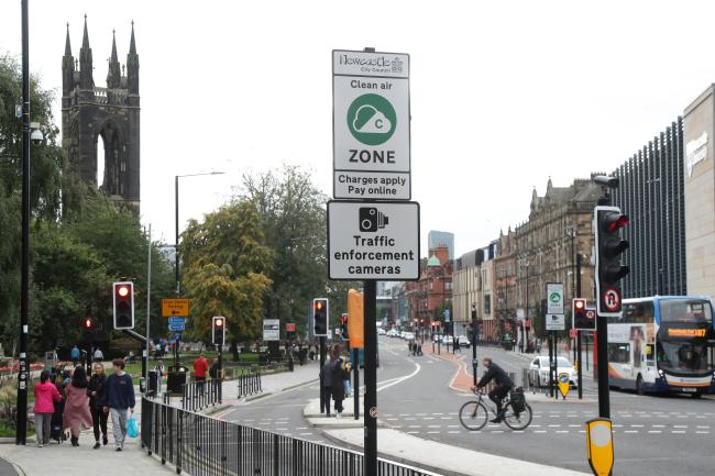 Photo shows a road sign alerting drivers to the Newcastle and Gateshead Clean Air Zone on a city street in Newcastle.
