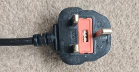 A black and red three pronged plug