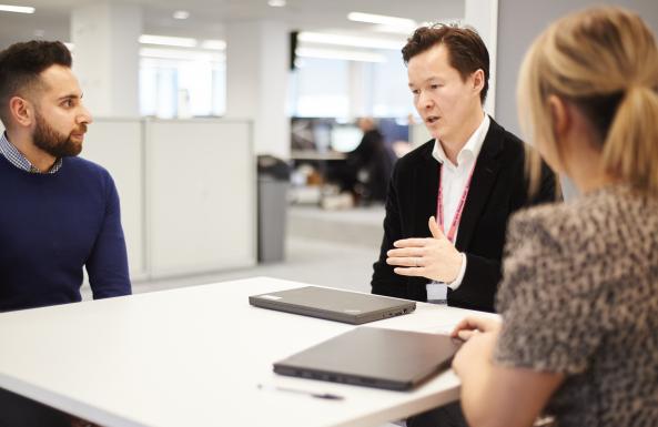 Three people in a meeting